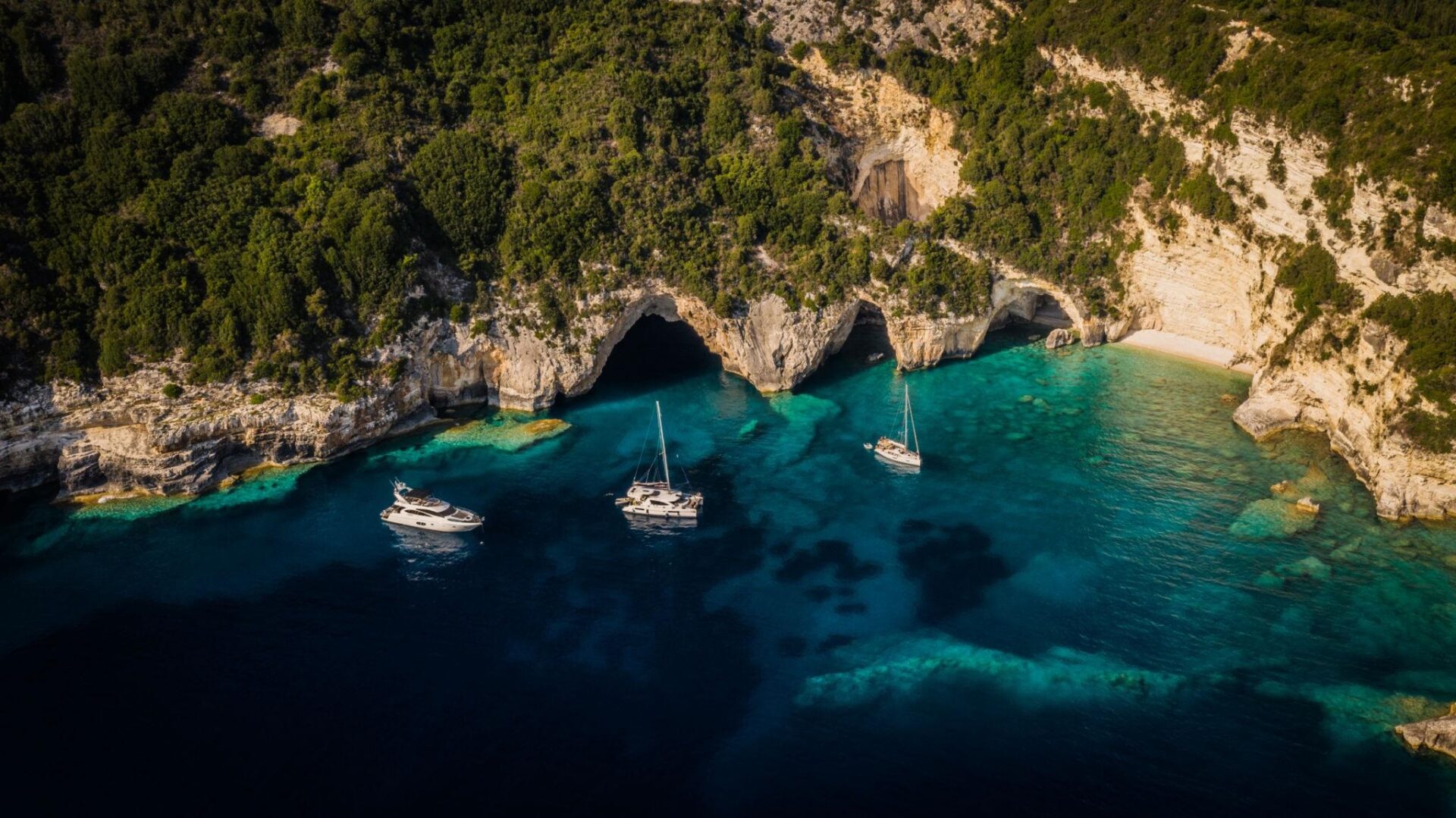 Aerial shot of yachts outside Blue Caves at Paxos island, Greece